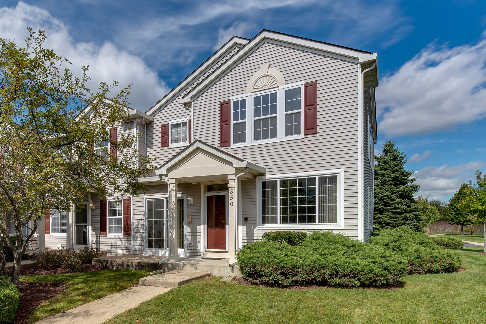 a front view of a house with a yard