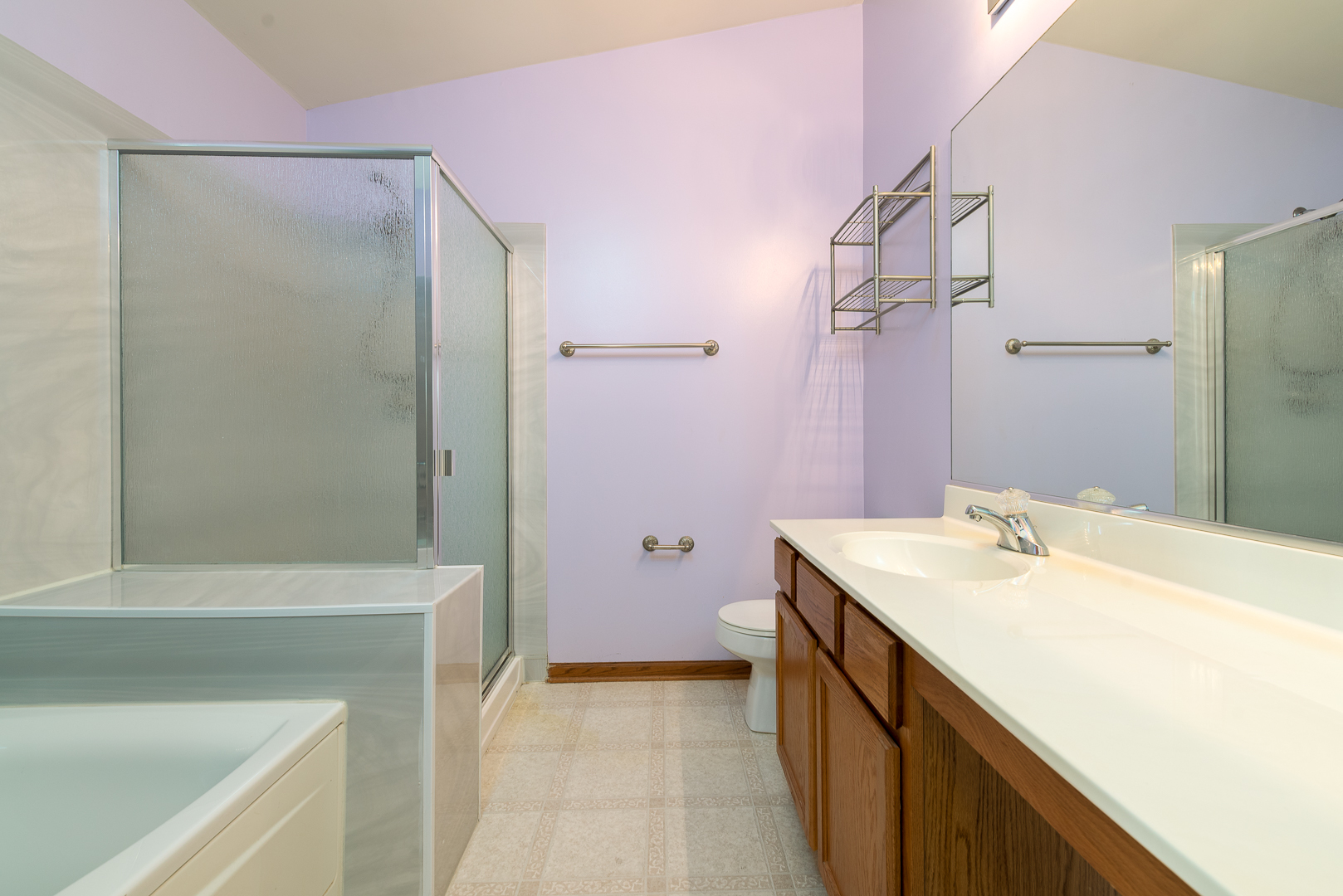 850 County Line Road, Unit 850 Aurora, IL 60502 - Photo 17 of 20 a bathroom with a sink a vanity and a mirror