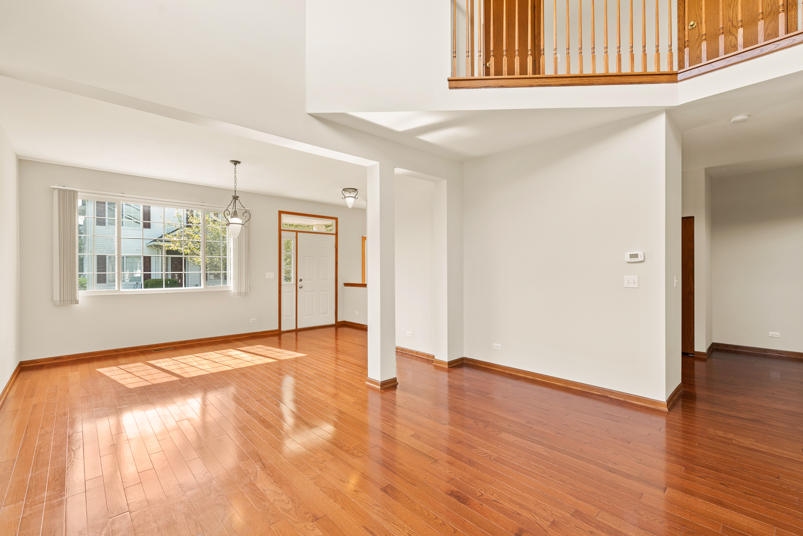 850 County Line Road, Unit 850 Aurora, IL 60502 - Photo 3 of 20 a view of an empty room with wooden floor and a window