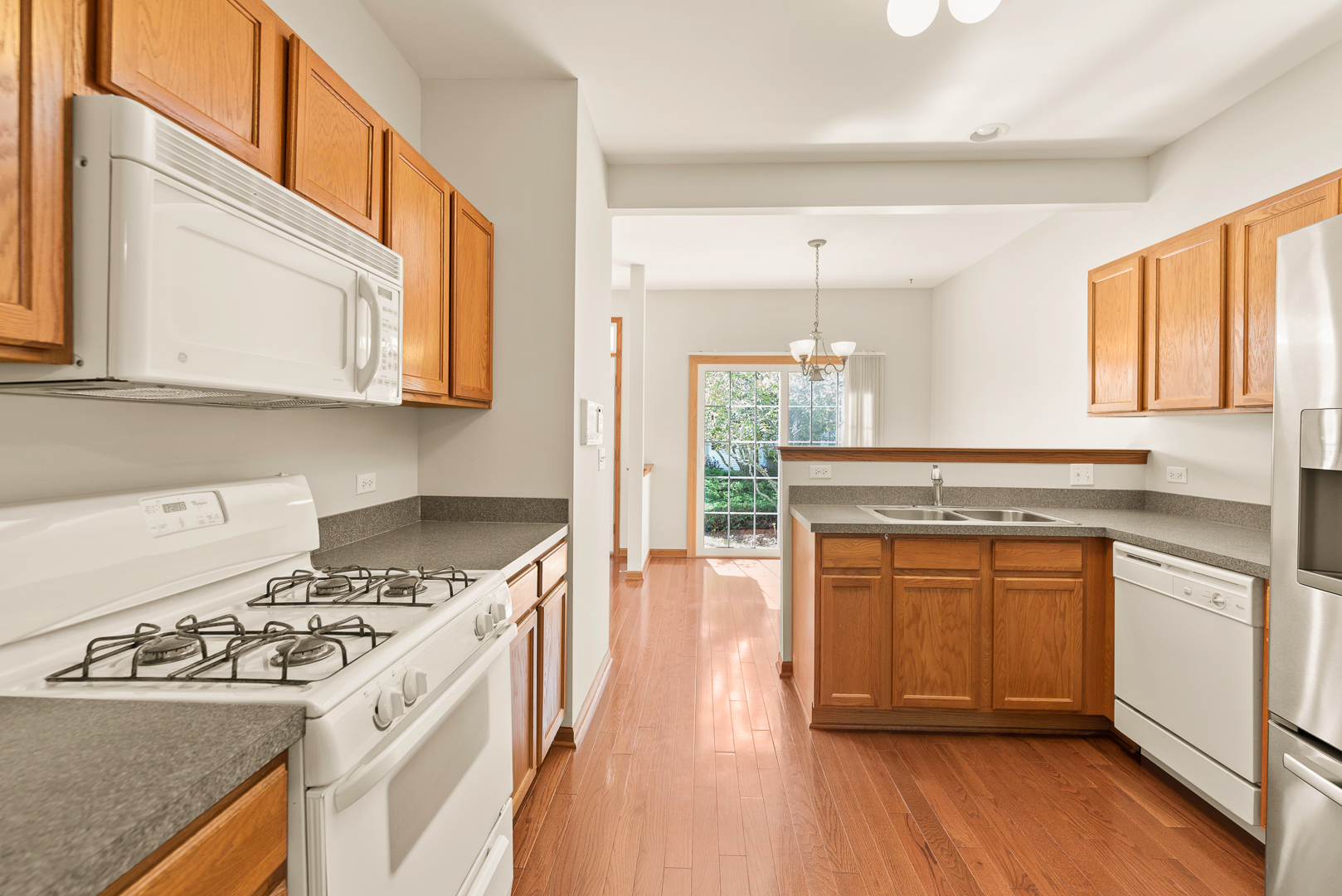 850 County Line Road, Unit 850 Aurora, IL 60502 - Photo 6 of 20 a kitchen with stainless steel appliances granite countertop a stove and a sink