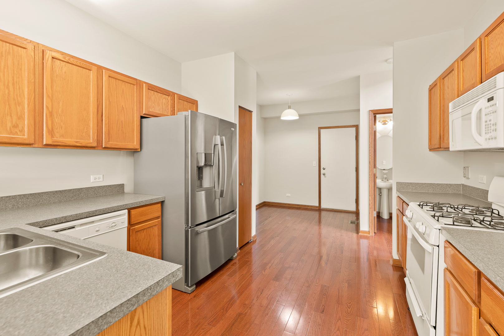 850 County Line Road, Unit 850 Aurora, IL 60502 - Photo 7 of 20 a kitchen with stainless steel appliances granite countertop a refrigerator a sink and a stove
