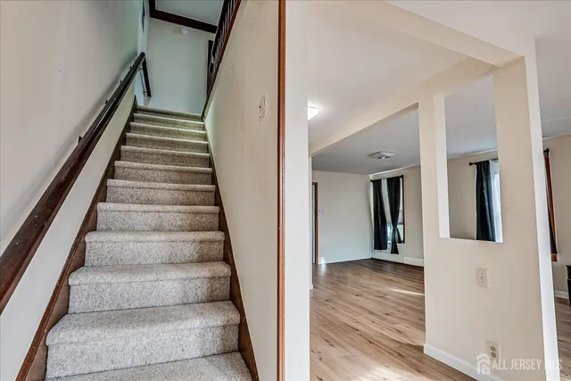a view of an entryway with wooden floor and stairs