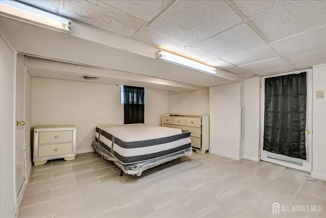 a spacious bedroom with a bed and a window