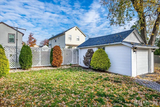 a view of a house with a yard and garage