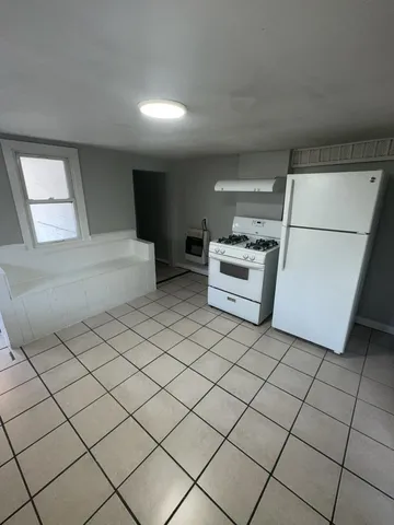 a kitchen with a sink and white cabinets