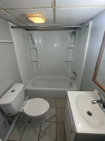 a bathroom with a sink a toilet and tub