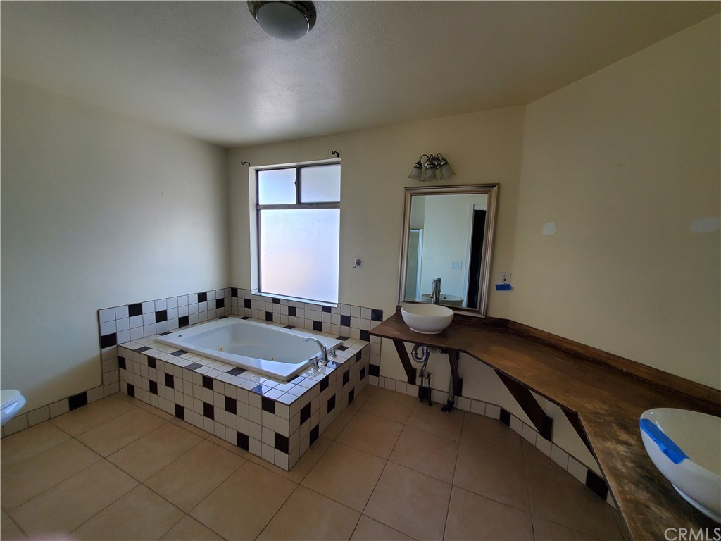 1685 Murrieta Road Perris, CA 92571 - Photo 12 of 19 a bathroom with a tub sink and mirror