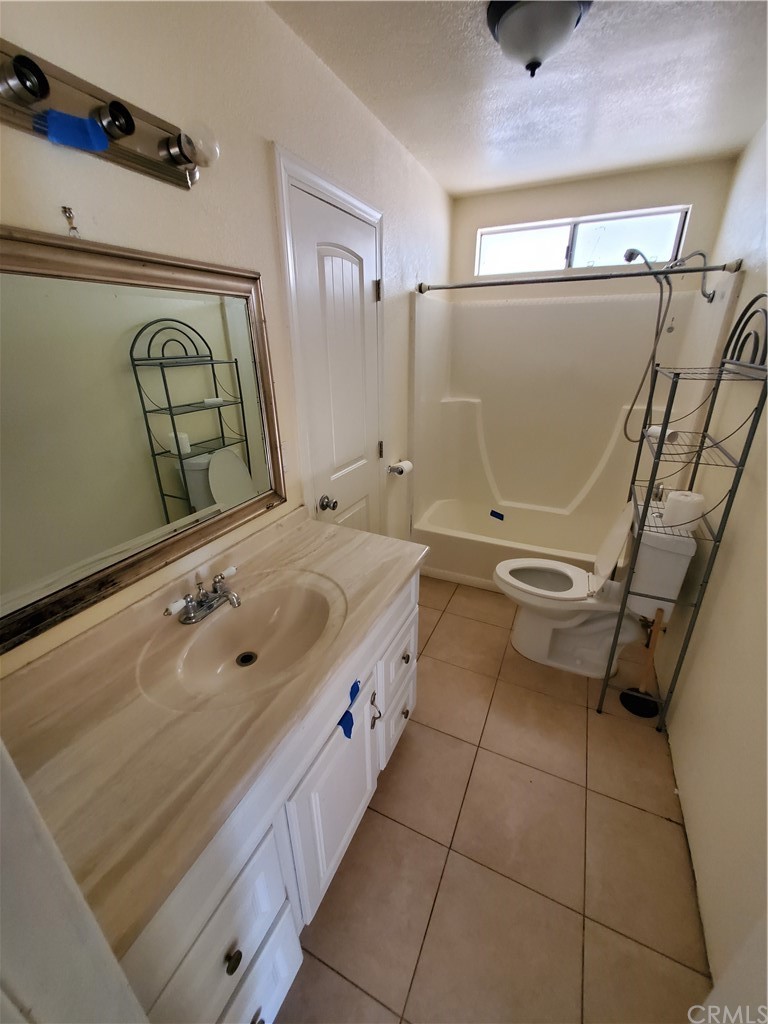 1685 Murrieta Road Perris, CA 92571 - Photo 15 of 19 a bathroom with a tub sink and mirror