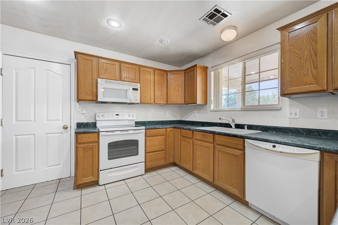 1272 Liston Avenue Logandale, NV 89021 - Photo 20 of 61 Functional kitchen with ample cabinetry and a bright window over the sink.