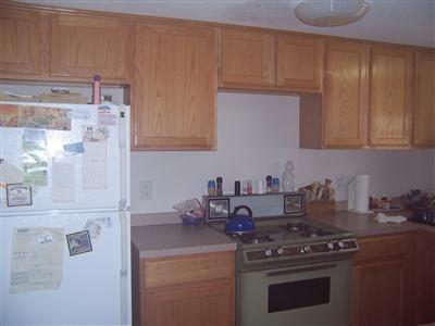 125 Captain Chase Road Dennis Port, MA 02639 - Photo 8 of 14 a kitchen with granite countertop a stove and a white cabinets