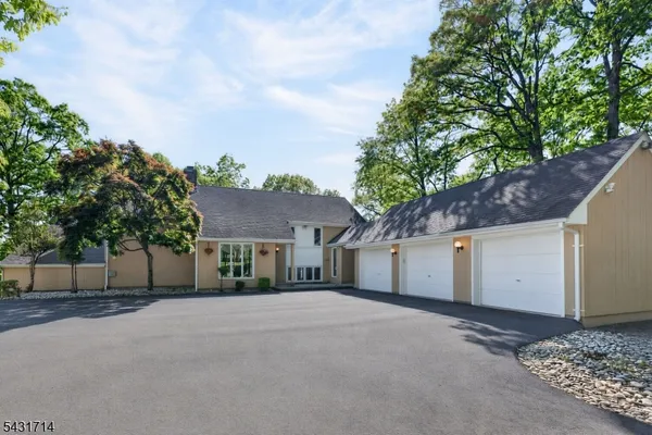 front view of a house with a yard and an trees