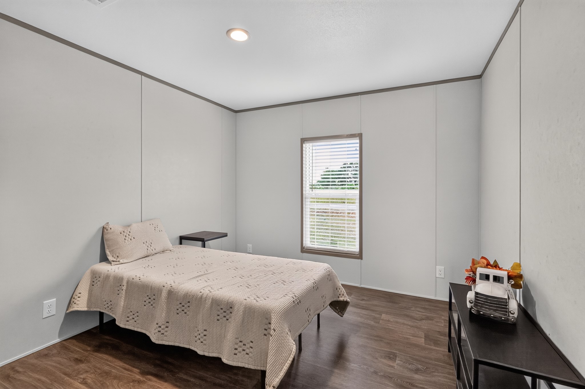 1134 Switchgrass Road Salado, TX 76571 - Photo 24 of 28 A well-lit bedroom features rich wood flooring, offering a peaceful retreat.