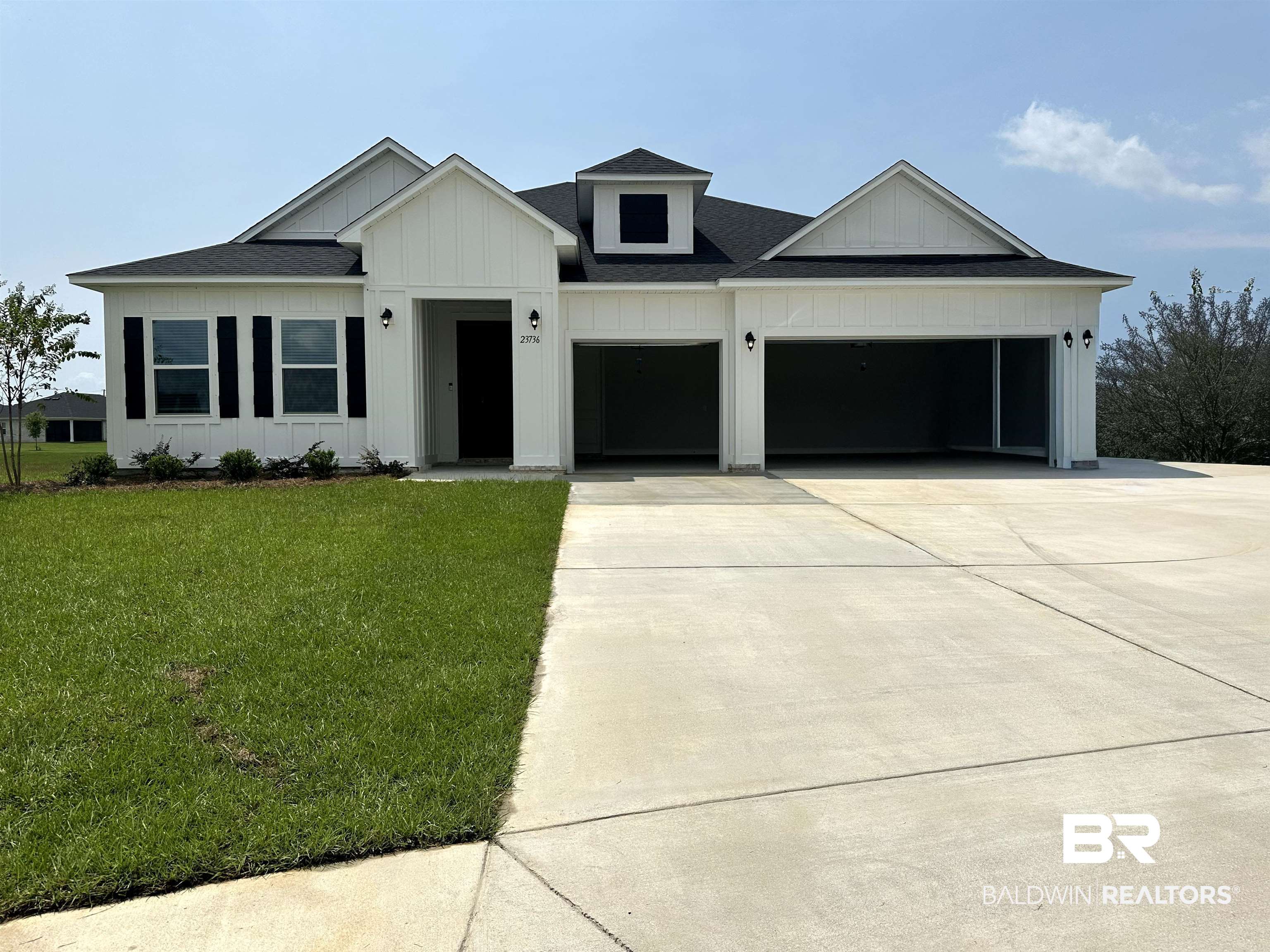 23736 Lafite Circle Daphne, AL 36526 - Photo 1 of 1 Modern farmhouse style home featuring board and batten siding, a garage, concrete driveway, a shingled roof, and a front lawn