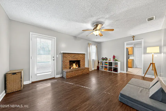a living room with furniture and a fireplace