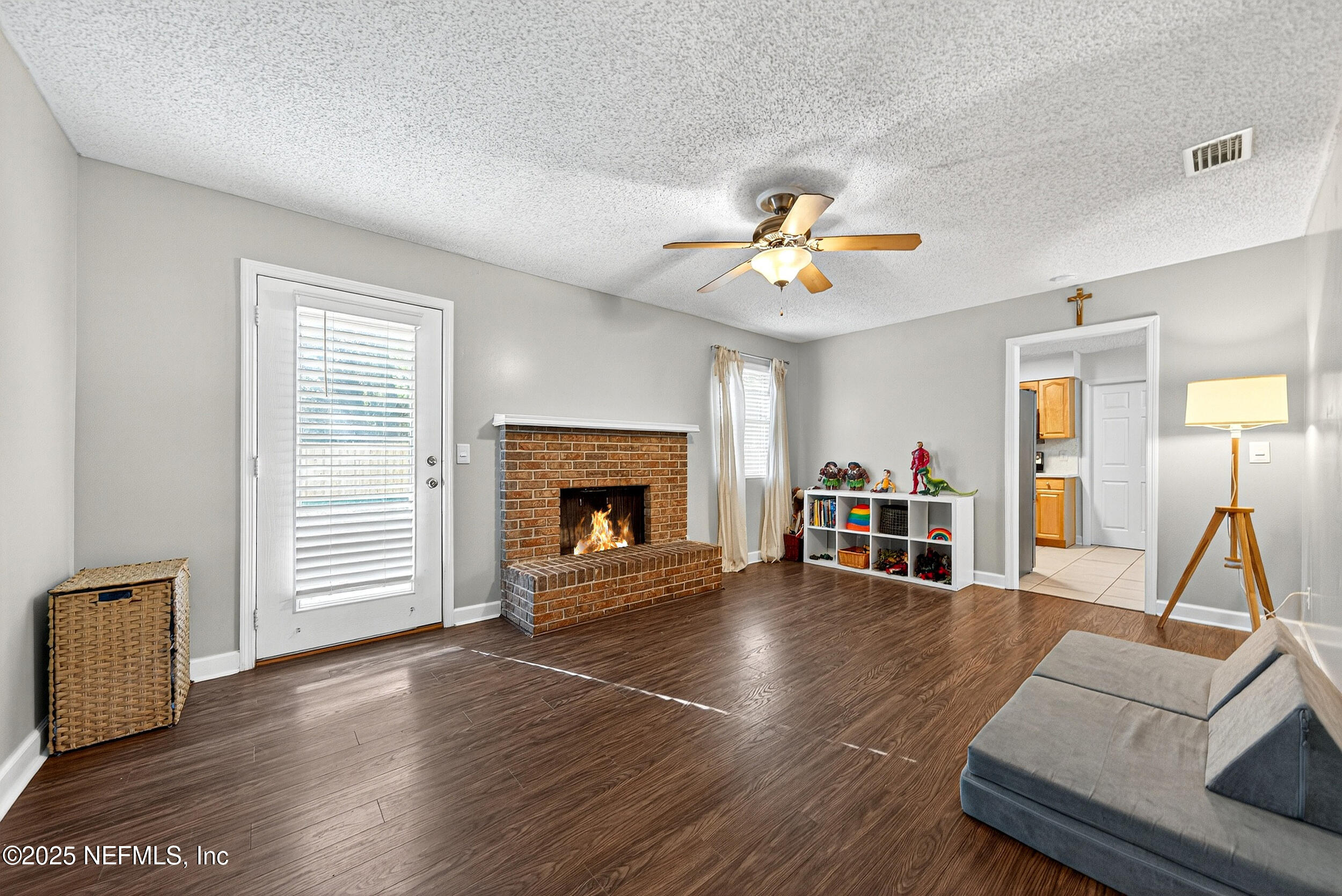 13808 Spanish Point Drive Jacksonville, FL 32225 - Photo 13 of 25 a living room with furniture and a fireplace