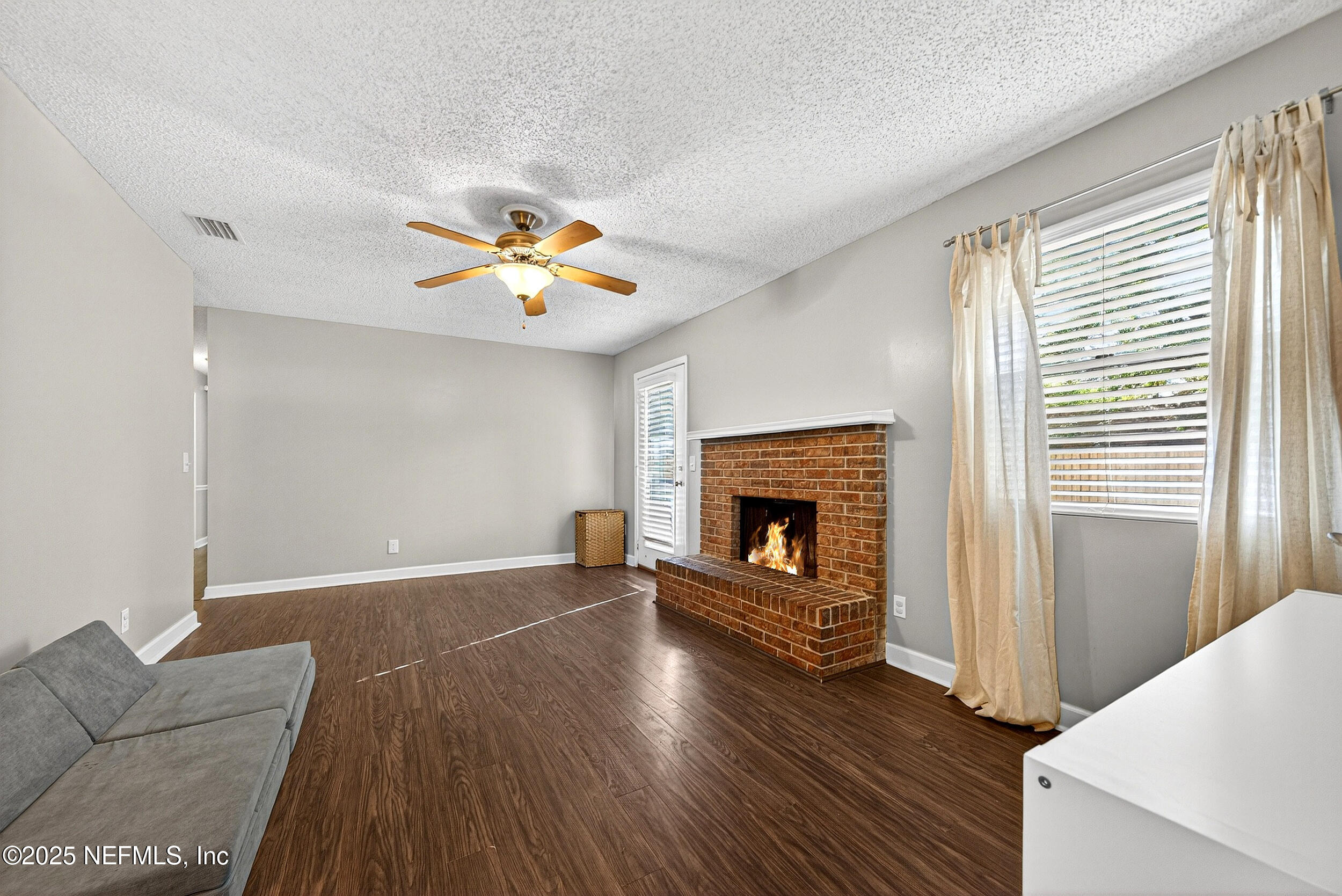 13808 Spanish Point Drive Jacksonville, FL 32225 - Photo 14 of 25 a living room with furniture and a fireplace