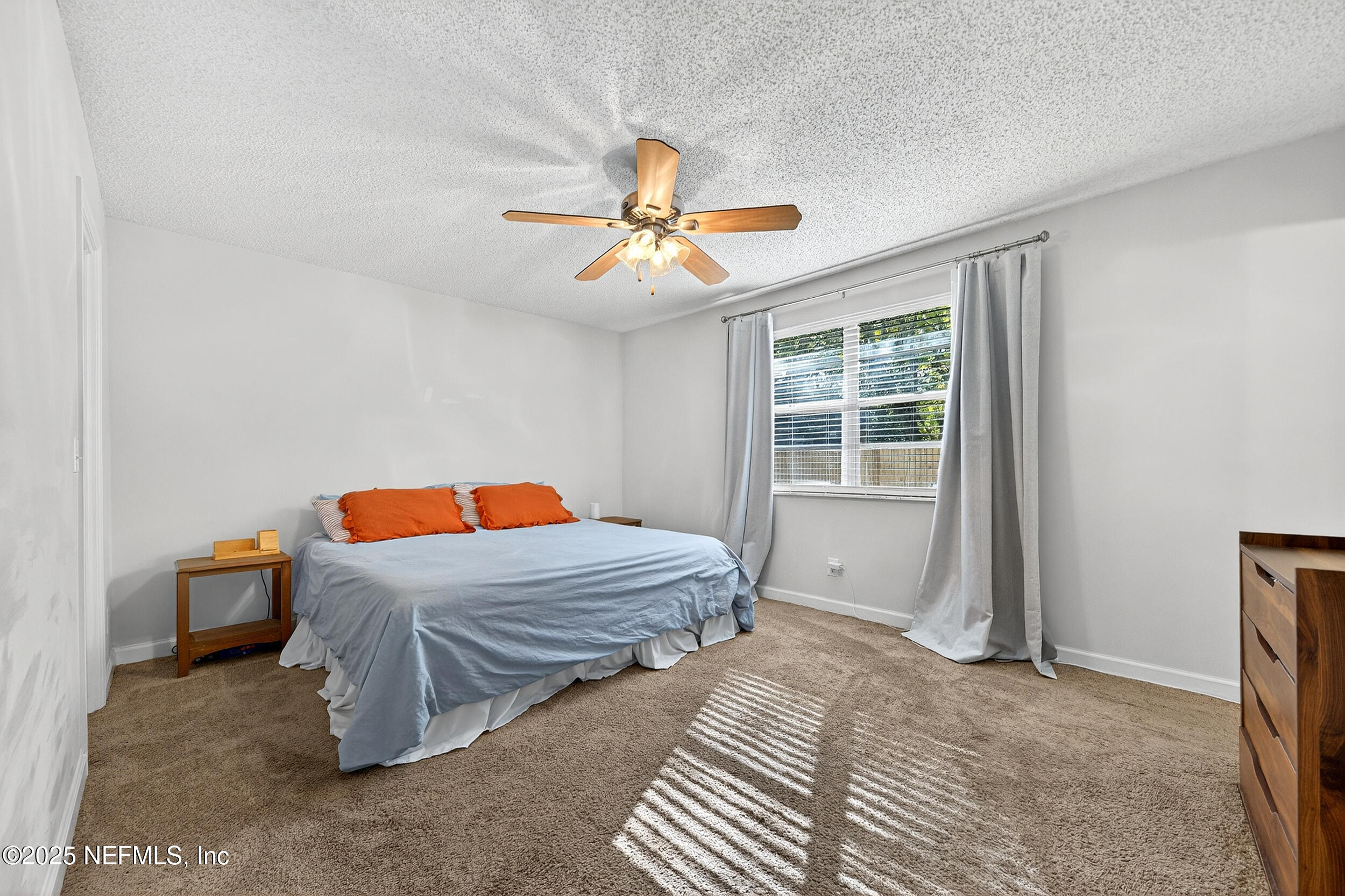 13808 Spanish Point Drive Jacksonville, FL 32225 - Photo 15 of 25 a bedroom with a bed and a chandelier