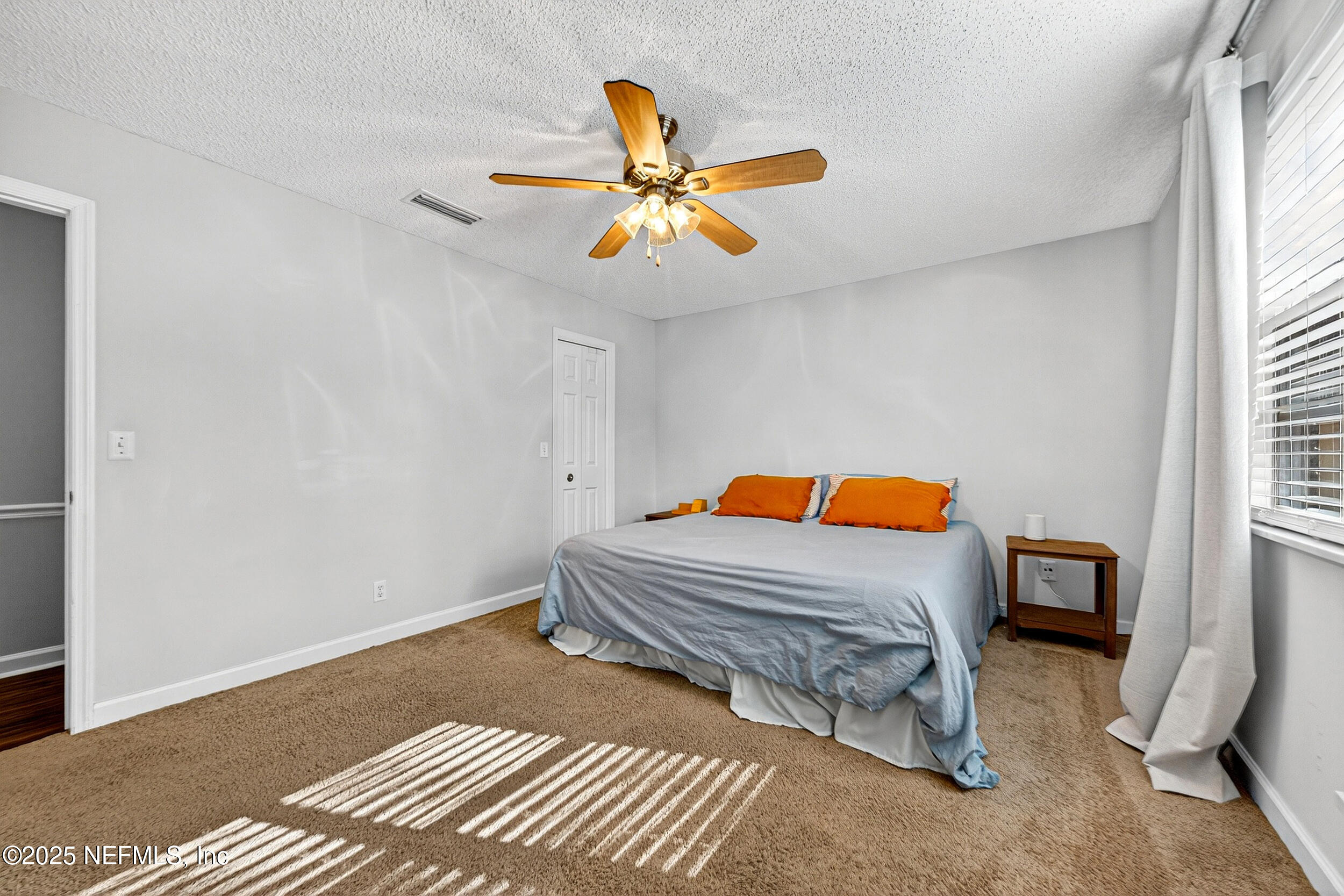 13808 Spanish Point Drive Jacksonville, FL 32225 - Photo 16 of 25 a bedroom with a bed and a chandelier
