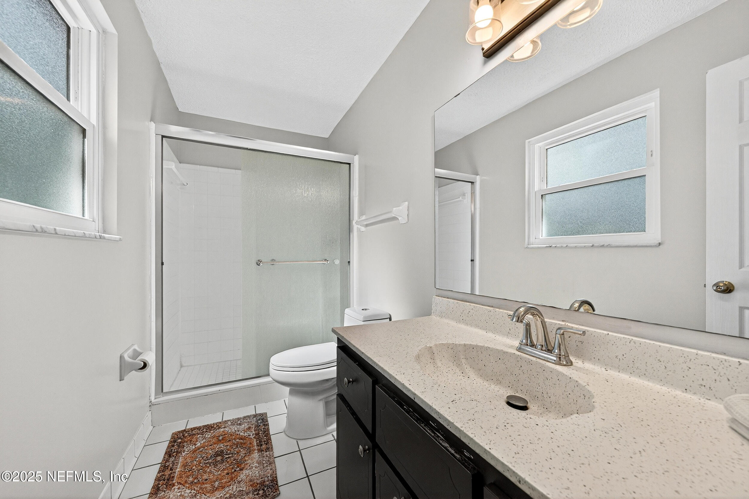 13808 Spanish Point Drive Jacksonville, FL 32225 - Photo 17 of 25 a bathroom with a sink and a mirror