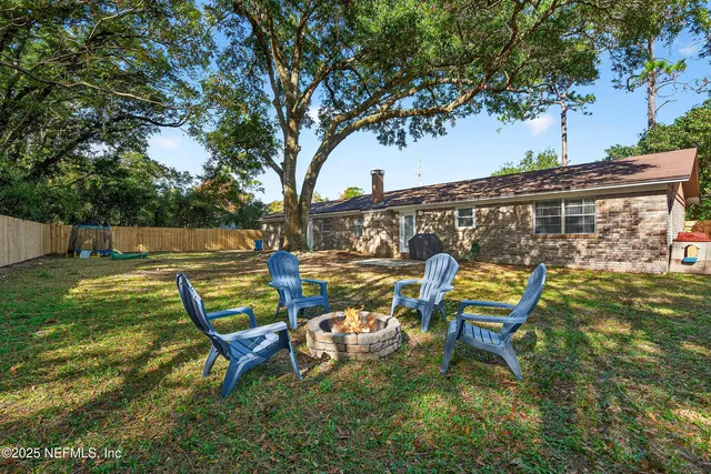 a swimming pool with outdoor seating and yard