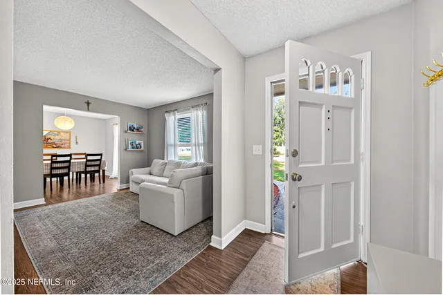 a living room with furniture and a dining table
