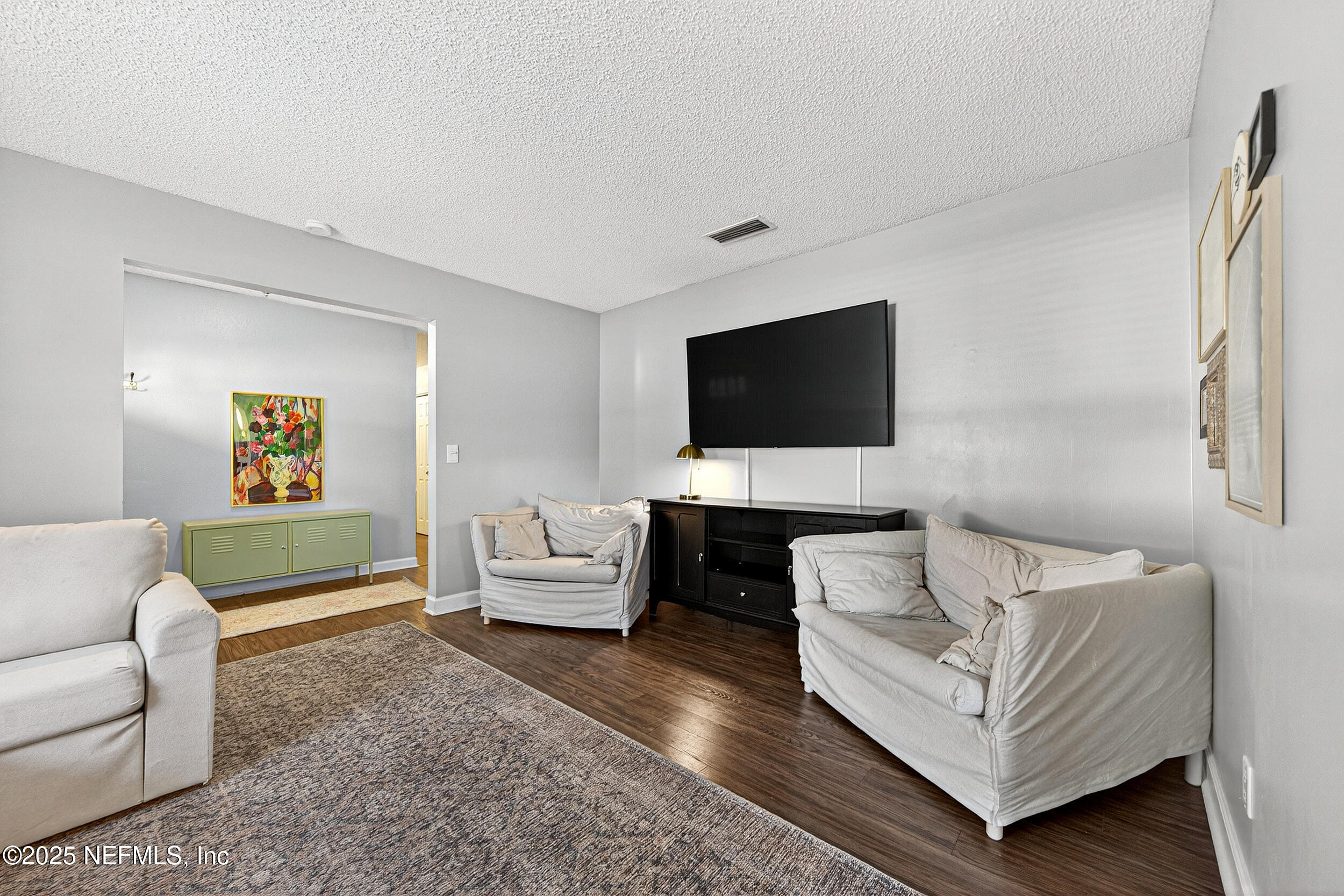 13808 Spanish Point Drive Jacksonville, FL 32225 - Photo 6 of 25 a living room with furniture and a flat screen tv