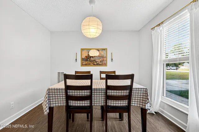 a view of a dining room with furniture and wooden floor