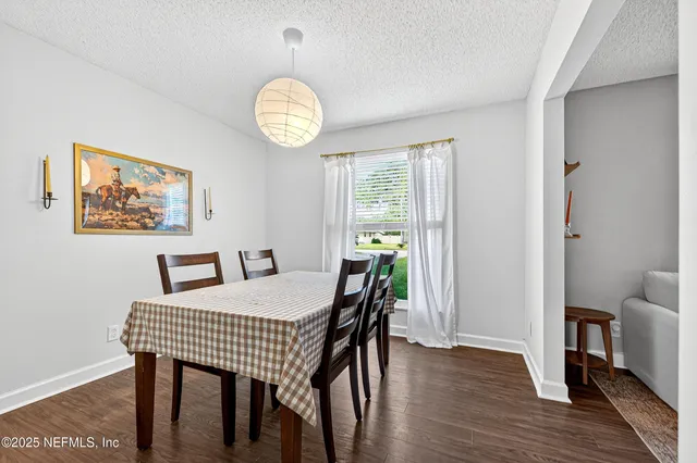 a view of a dining room with furniture window and wooden floor