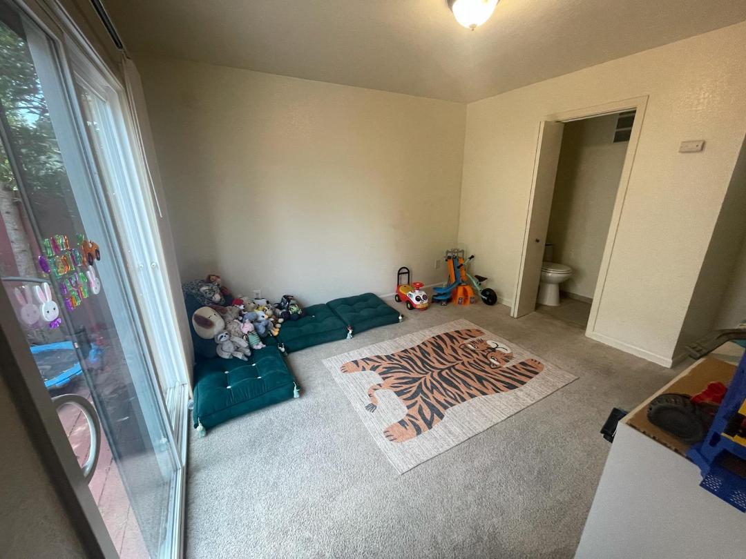 1702 Goodwin Street Seaside, CA 93955 - Photo 2 of 6 a bed sitting in a bedroom next to a window