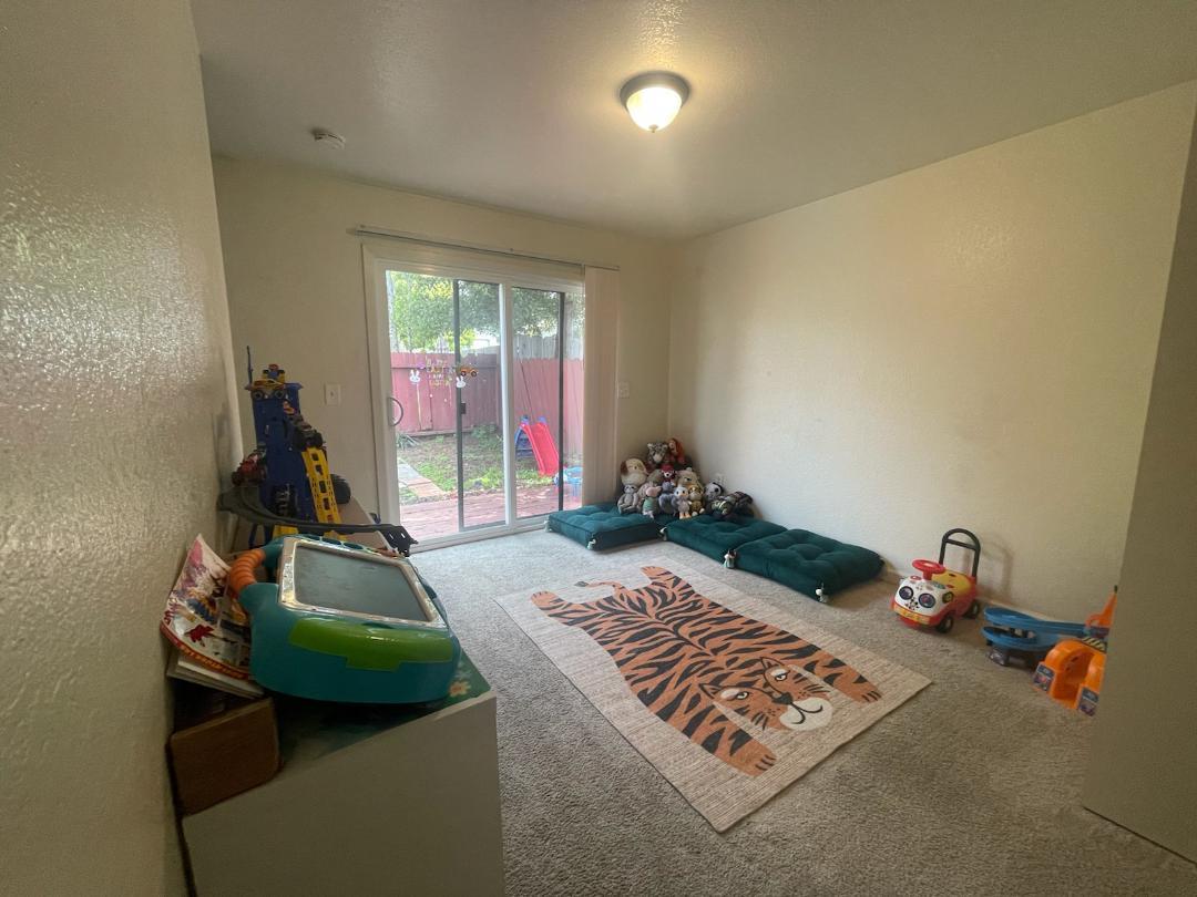 1702 Goodwin Street Seaside, CA 93955 - Photo 3 of 6 a bedroom with furniture and a wooden floor