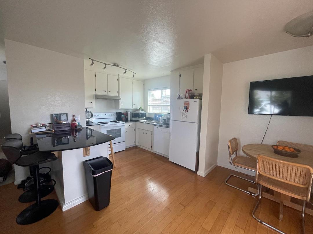 1702 Goodwin Street Seaside, CA 93955 - Photo 4 of 6 a kitchen with a refrigerator and a stove top oven