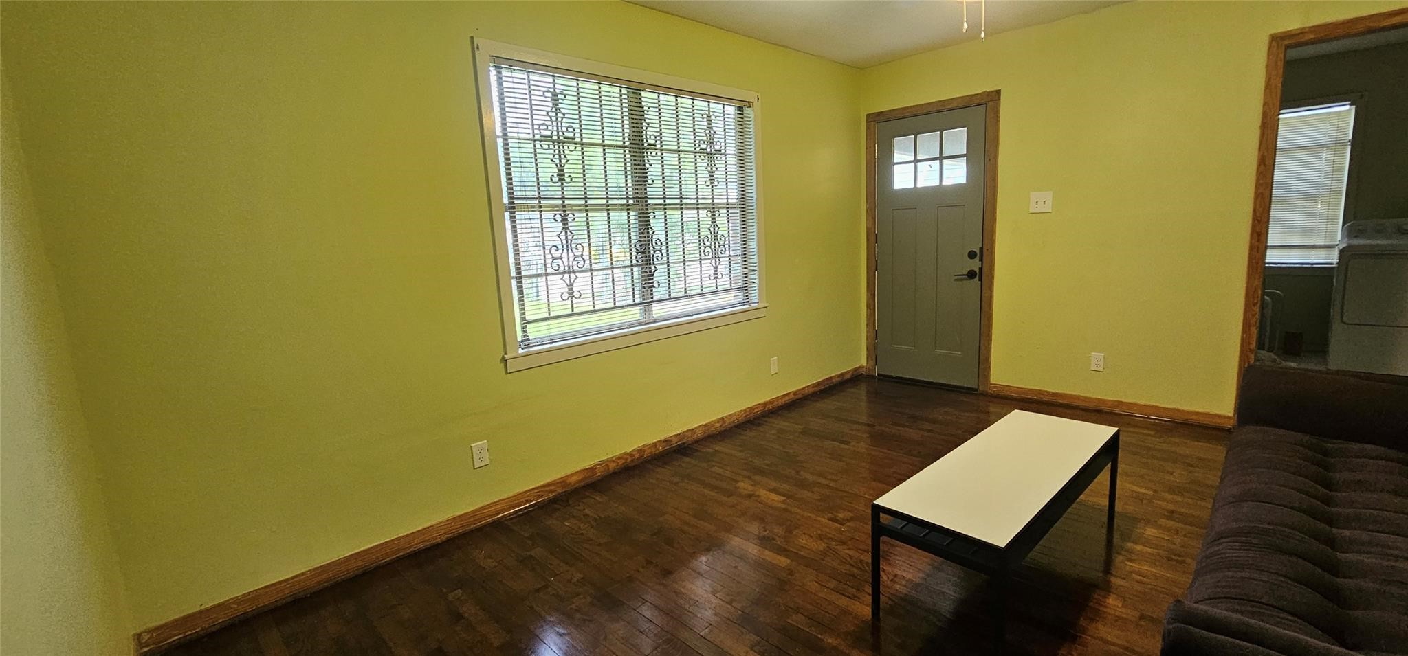3610 Dennis Street Houston, TX 77004 - Photo 4 of 16 Interior entry opens into the main living space with wood flooring and secure window features for added privacy.