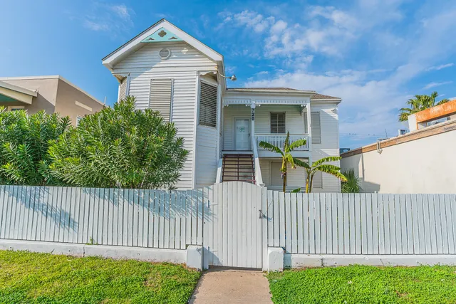 a front view of a house with iron fence