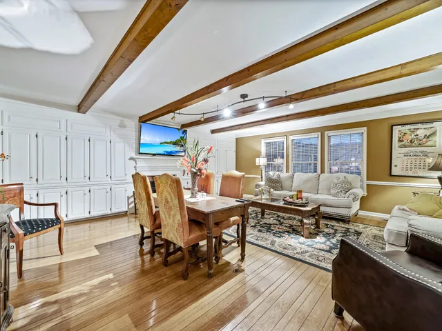 a view of a dining room with furniture wooden floor and a rug