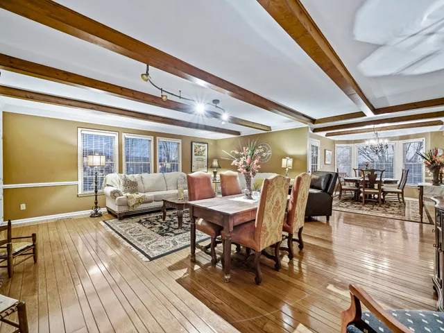 a dining room with lots of furniture and wooden floor