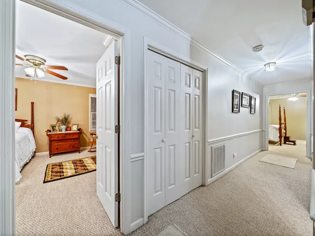a view of a hallway to a livingroom with furniture