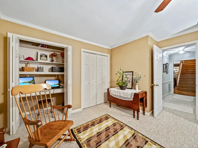 a living room with furniture and a book shelf