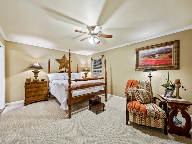 a bedroom with furniture and a chandelier