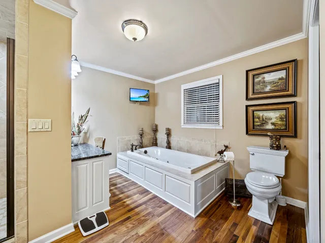 a spacious bathroom with a double vanity sink a mirror and a toilet