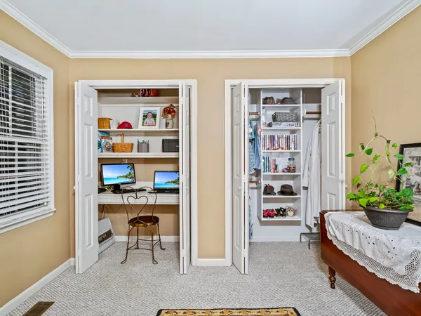 a living room with furniture and a book shelf