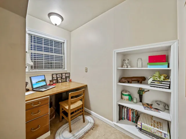 a room that has a table and a bookshelf