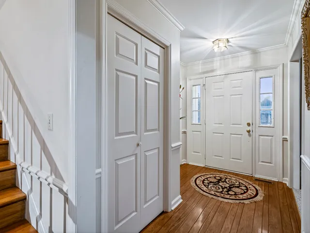a view of a hallway with a door and wooden floor
