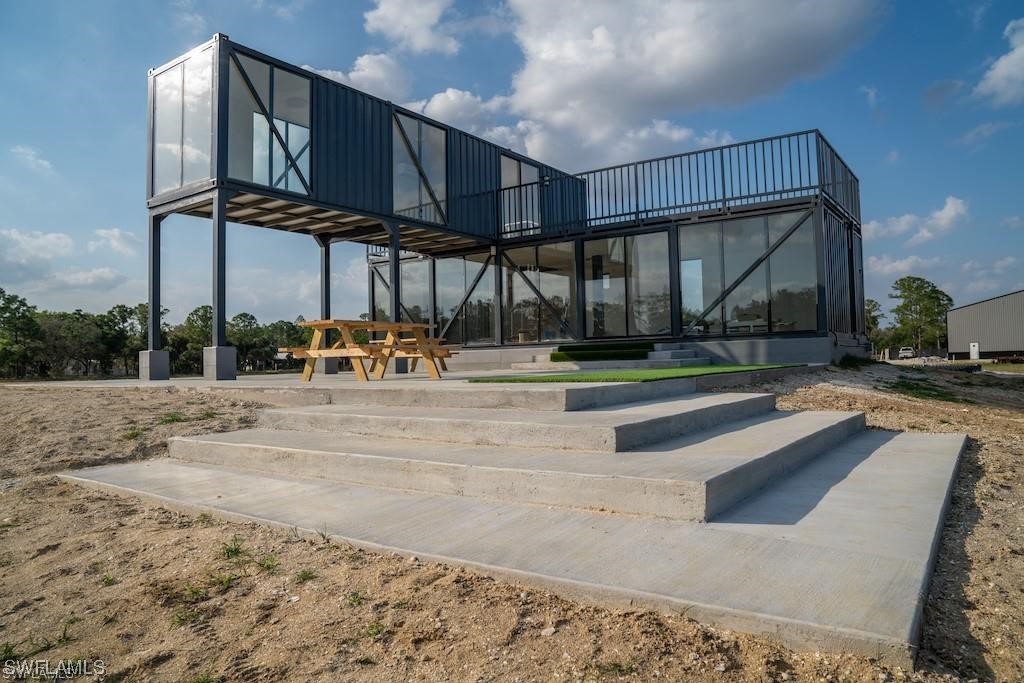1422 Gate Road LaBelle, FL 33935 - Photo 10 of 16 a view of a swimming pool with a bench in patio