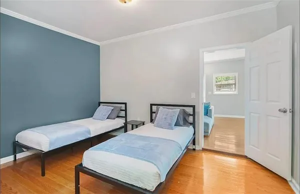 a bedroom with two beds and lamps
