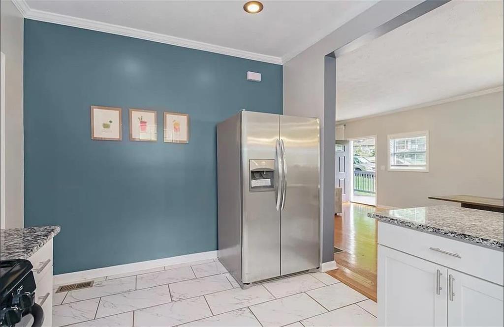 411 Dorsey Road Atlanta, GA 30354 - Photo 4 of 19 a bathroom with a granite countertop sink and a refrigerator
