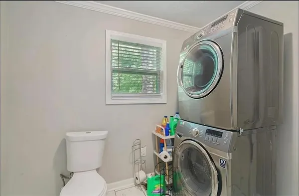 a view of a bedroom with washer and dryer