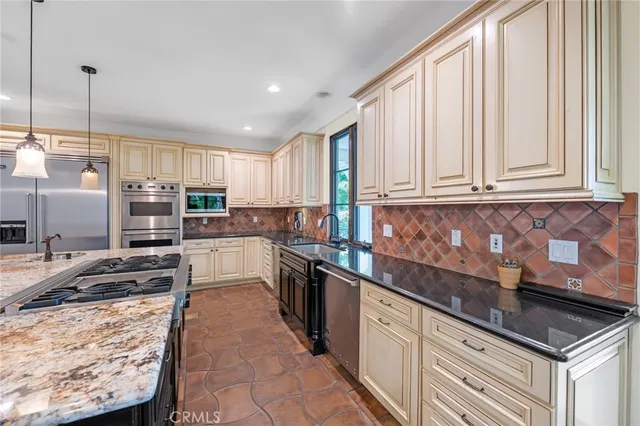 a kitchen with stainless steel appliances granite countertop a stove and a refrigerator