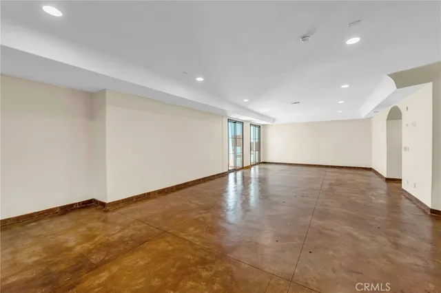 an empty room with a empty space and windows