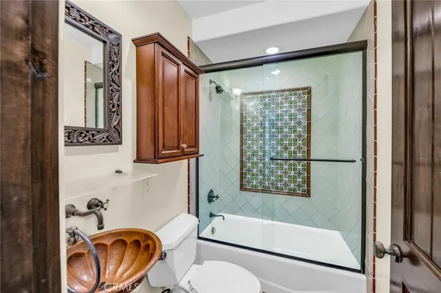 an empty room with wooden floor and a ceiling fan