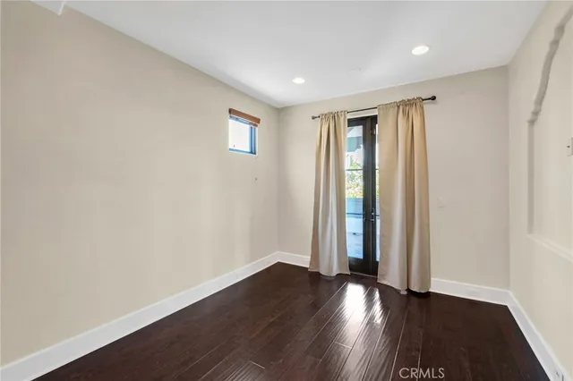 a view of hallway with wooden floor and a rug